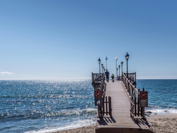 Seaside pier in Marbella, symbolizing the lifestyle and location appeal for foreign property buyers.